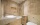 Salle de bain contemporaine avec douche et meuble en travertin