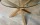 Table basse en verre et bois sur carrelage travertin